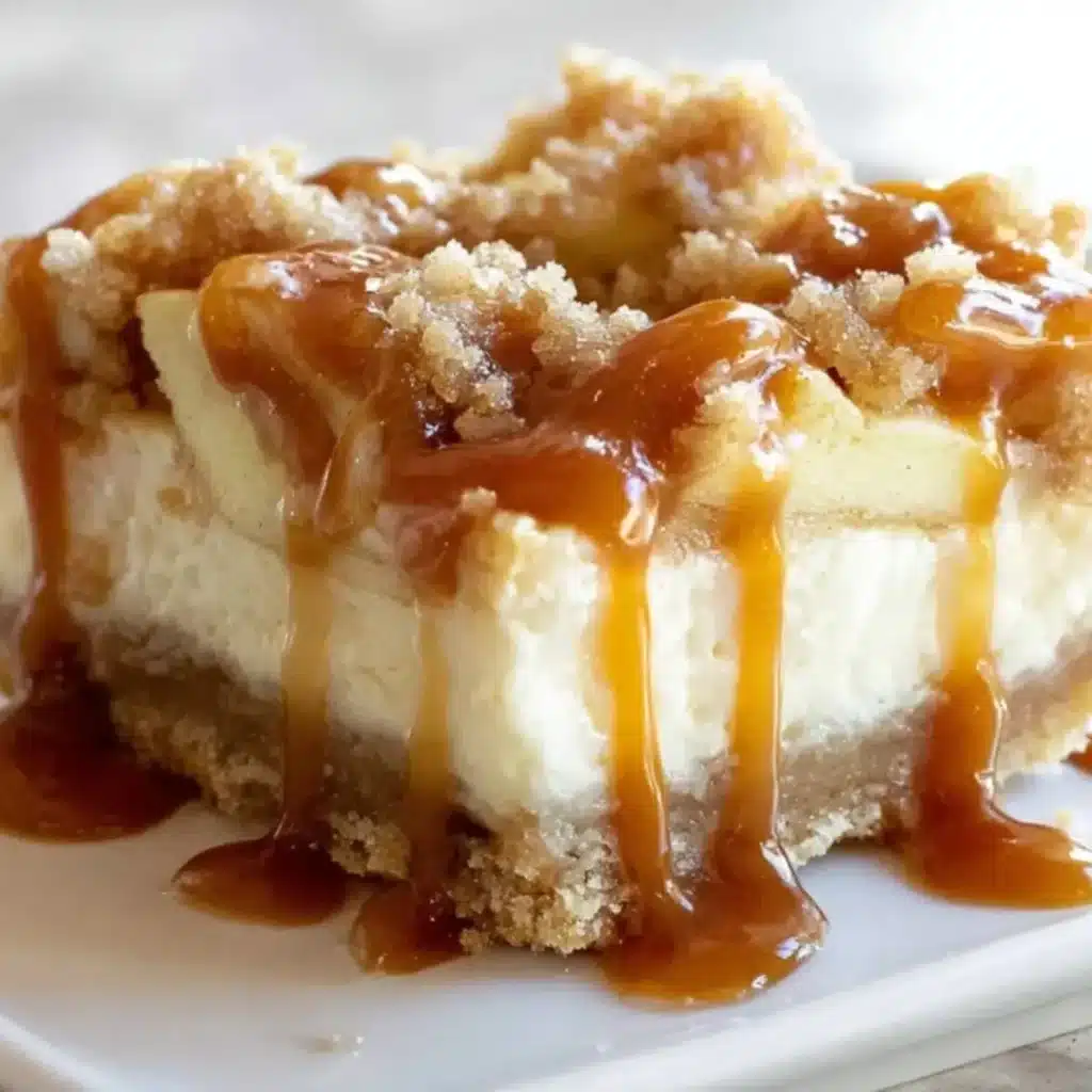 Caramel Apple Cheesecake Bar with thick graham cracker crust, creamy cheesecake layer, spiced apple topping, streusel crumbs, and a generous drizzle of sticky caramel sauce.