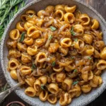 A rustic bowl of {{ $('Fetch Recipe Data').first().json["Main Keyword"] }} mixed with caramelized onions and sage.