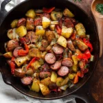 Cast iron {{ $('Fetch Recipe Data').first().json["Main Keyword"] }} with bell peppers and fresh herbs.